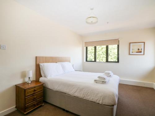 a bedroom with a large bed and a window at Flat 33 - Marine Court in Littlehampton