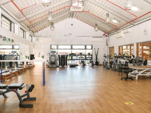a gym with treadmills and cardio equipment in a room at Flat 33 - Marine Court in Littlehampton