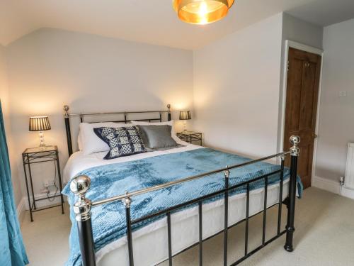 a bedroom with a bed with a blue comforter at Cliff House in York