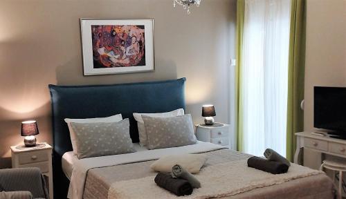 Schlafzimmer mit einem großen Bett mit blauem Kopfteil in der Unterkunft City Stay Alexandras Av. in Athen