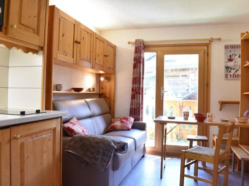 a living room with a couch and a kitchen at Charmant Studio au Pied des Pistes - Balcon Sud - 3 Pers - Méribel - FR-1-180-34 in Méribel