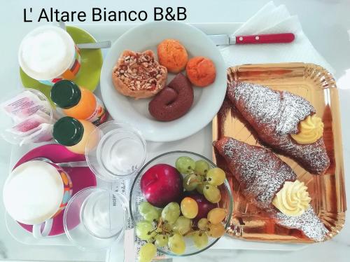 a table with a plate of breakfast foods and drinks at B&B L'Altare Bianco in Vieste