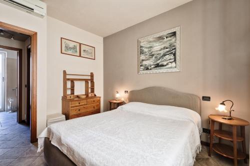 a bedroom with a white bed and two night stands at Moleloca - San Tommaso Apartment in Turin