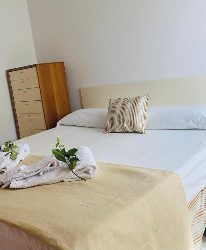 a bedroom with two beds with a blanket and a dresser at La Rocchetta, Borgo Valsugana in Borgo
