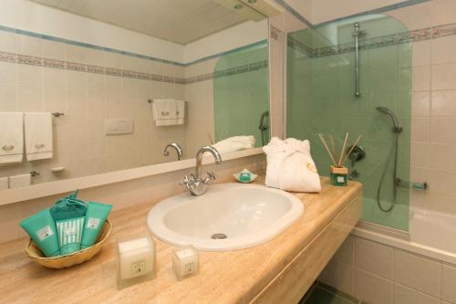 a bathroom with a sink and a shower at Hotel Biodola in Portoferraio