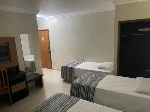 Una cama o camas en una habitación de JVA Fenix Hotel