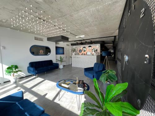 a living room with blue chairs and a table at Kazbegi Apartments in Stepantsminda