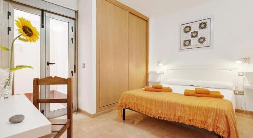 a bedroom with a bed and a room with a window at APARTMENT ORANGE FUERTEVENTURA in Puerto del Rosario