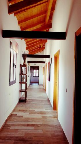 an empty hallway of a building with a wooden ceiling at Finca La Calancha in Cuerva
