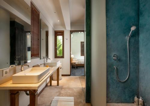 a bathroom with two sinks and a shower at Villa Markisa Echo Beach in Canggu