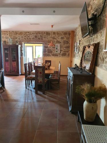 a living room with a table and a dining room at Finca La Calancha in Cuerva