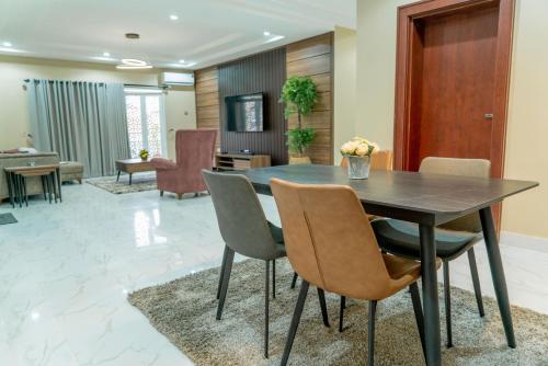 a dining room with a table and chairs at Integral Consults Apartment in Abuja