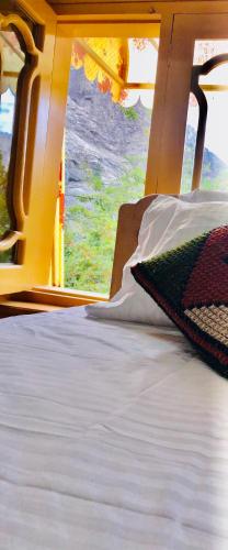 a bed in a room with a view of a window at North Palace Khaplu in Khaplu