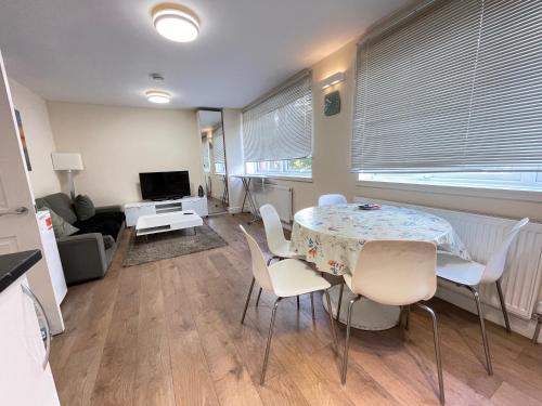 a living room with a table and chairs at Westminster House in Slough