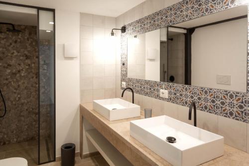 a bathroom with two sinks and a mirror at Masseria Specchiulla in Otranto