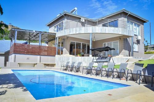 a house with a swimming pool in front of a house at Mountain Beauty in Mbabane