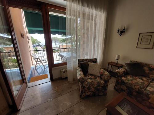 a living room with a couch and a balcony at BIBAHOME in Cogoleto