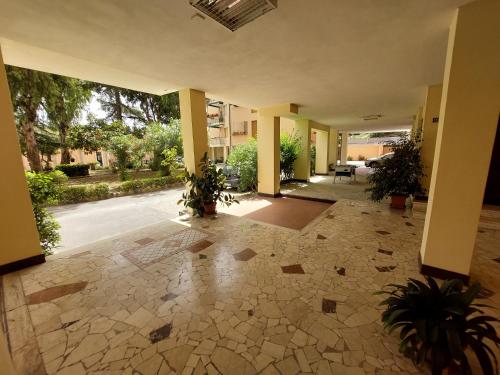 an empty lobby with plants in a building at BIBAHOME in Cogoleto