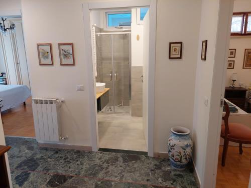 a bathroom with a shower and a glass door at BIBAHOME in Cogoleto