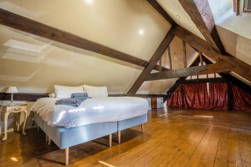 a bedroom with a white bed in a attic at Remarkable 4-Bed Cottage in Cearleon in Newport