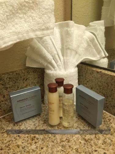 a bathroom counter with two bottles of soap and towels at Hawthorn Suites by Wyndham Rancho Cordova/Folsom in Rancho Cordova