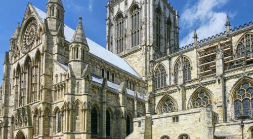 a large cathedral with turrets and a large building at Galtres Lodge Hotel & Forest Restaurant in York