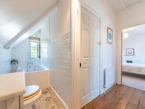 a bathroom with a toilet and a tub and a sink at Pass the Keys Victorian Flat A Stones Throw From Hampton Court in East Molesey