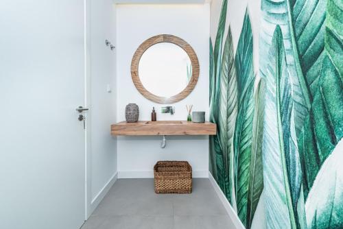 a bathroom with a mirror and a sink at Casa da Oliveira ~ Azeitão in Azeitao