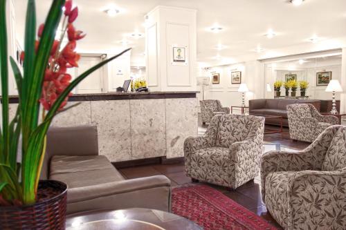 a living room with chairs and a bar at CHA Prime Curitiba in Curitiba
