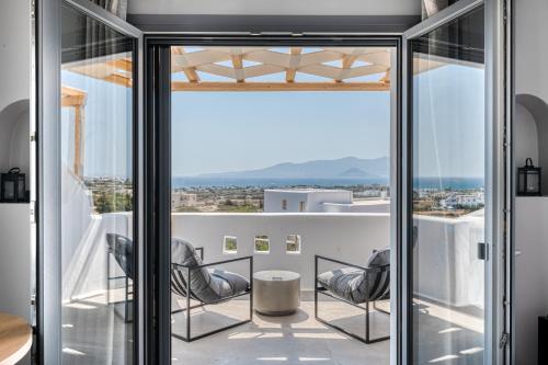 a view from the balcony of a house with chairs at Mirabelle Luxury Villas in Plaka