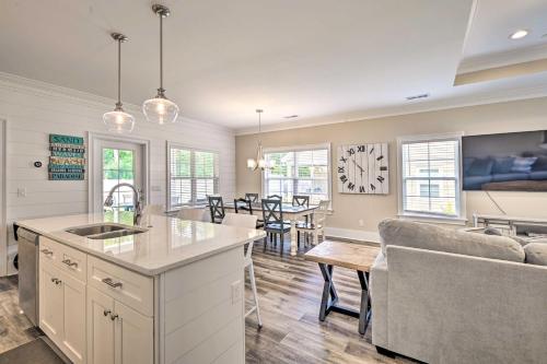 a kitchen and living room with a couch and a table at Charming Pawleys Island Home about 4 Mi to Beach! in Pawleys Island