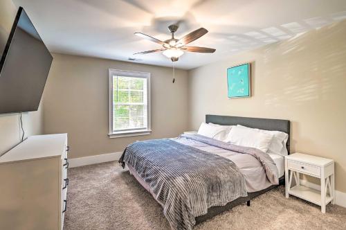 a bedroom with a bed and a ceiling fan at Charming Pawleys Island Home about 4 Mi to Beach! in Pawleys Island
