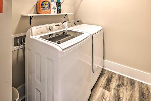 a washer and dryer in a small laundry room at Charming Pawleys Island Home about 4 Mi to Beach! in Pawleys Island