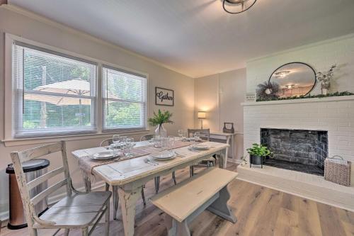 a dining room with a table and a fireplace at Charming Retreat on 5 Acres with Deck and Grill! in Monticello