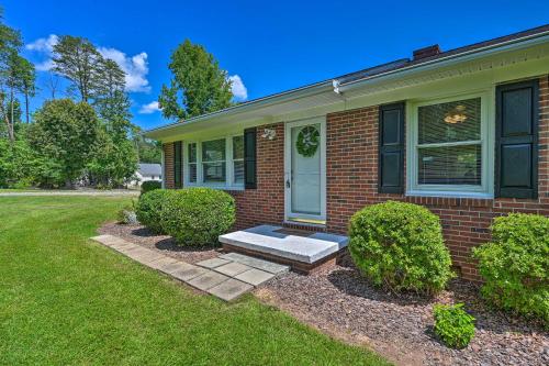 a brick house with a bench in the front yard at Charming Retreat on 5 Acres with Deck and Grill! in Monticello