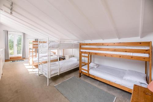 a bedroom with three bunk beds in a room at The Shealing, Waldringfield (Air Manage Suffolk) in Waldringfield