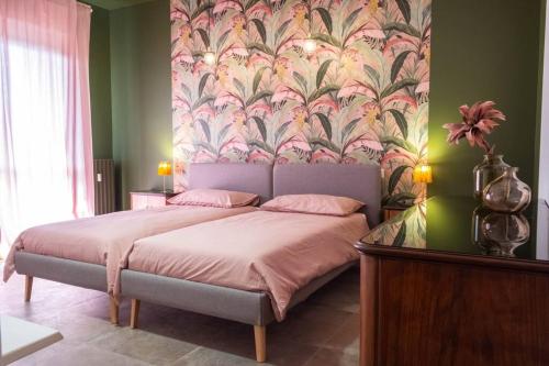 1 dormitorio con 1 cama y papel pintado con motivos florales en LaCasadiPI - appartamento ad un passo da Milano - FieraMilanoRho - H Galeazzi - MIND, en Rho