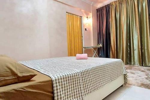a bedroom with a bed with a pink box on it at Comfy Stay @Permai Puteri Ampang nearby KLCC, IJN in Ampang