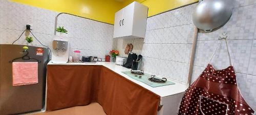 a small kitchen with a counter and a refrigerator at Comfy Stay @Permai Puteri Ampang nearby KLCC, IJN in Ampang
