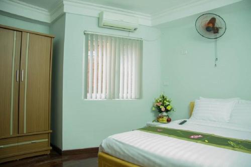 a bedroom with a white bed and a window at VIETNAM APPLE HOMESTAY in Hanoi