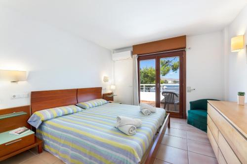 a bedroom with a bed and a living room at Camp de Mar in Alcudia