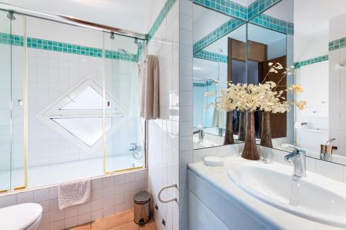 a bathroom with a sink and a mirror at Camp de Mar in Alcudia