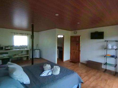 a bedroom with a bed with white shoes on it at Tapiru's House - Bahia Drake in Drake
