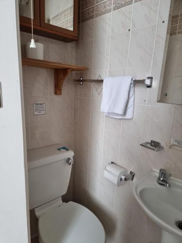a bathroom with a white toilet and a sink at Casablanca in Blackpool