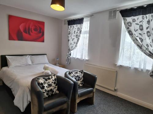 a bedroom with a bed and two chairs at Casablanca in Blackpool