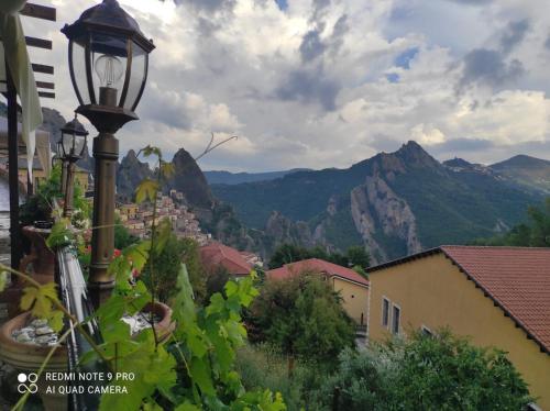 a street light with mountains in the background at Monserrat in Castelmezzano