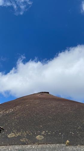 a hill with clouds on top of it at Blue Marine Taormina in Taormina