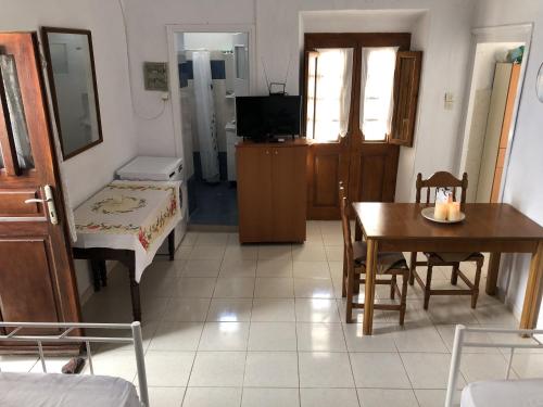 a living room with a table and a dining room at Palaia katoikia Amazing View Pyrgos Santorini in Pyrgos
