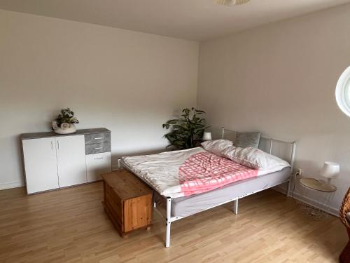 a bedroom with a bed and a cabinet in it at Ferienwohnungen Waldblick in Remscheid