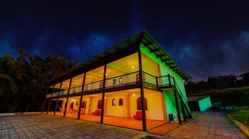a house with a lit up facade at night at Pousada Casarão na Serra in Vargem Bonita